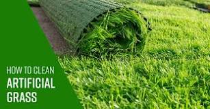 How do professionals clean artificial grass?