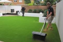 What should you put down before laying artificial grass?
